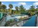 Beautiful pool surrounded by lush greenery and mature palm trees at 61 E Bayshore Dr, Port Orange, FL 32127