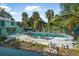 Spacious pool area with lounge chairs, lush plants, and a charming seating area at 61 E Bayshore Dr, Port Orange, FL 32127