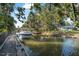 Waterfront property featuring a boat dock, canopy, and scenic views of the canal at 61 E Bayshore Dr, Port Orange, FL 32127