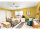 Sunny bedroom with a ceiling fan, cozy furniture, and plenty of natural light at 625 N Halifax Ave # 11, Daytona Beach, FL 32118