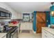Charming kitchen featuring stainless steel appliances, white cabinetry, and a stylish sliding barn door at 625 N Halifax Ave # 11, Daytona Beach, FL 32118
