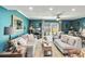 Bright living room with hardwood floors, comfortable seating, and sliding glass doors to the patio at 625 N Halifax Ave # 11, Daytona Beach, FL 32118