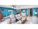 Open-concept living area with contemporary furnishings, bright blue walls, and lots of natural light at 625 N Halifax Ave # 11, Daytona Beach, FL 32118