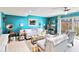 Stylish living room with sliding glass doors, comfortable couches, and a modern ceiling fan at 625 N Halifax Ave # 11, Daytona Beach, FL 32118