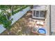 Aerial view of backyard including screened porch, small pool, and outdoor games at 700 Spring Cavern Ave, Orange City, FL 32763