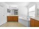 Bright bathroom with a soaking tub, tiled floors, and dual sinks at 700 Spring Cavern Ave, Orange City, FL 32763