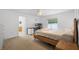 Bright bedroom featuring a modern desk area, ceiling fan, and neutral carpet at 700 Spring Cavern Ave, Orange City, FL 32763