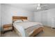 Bedroom with a wood-accent headboard and geometric wall art at 700 Spring Cavern Ave, Orange City, FL 32763