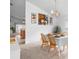 Dining room features artwork, table setting, and views of the kitchen area at 700 Spring Cavern Ave, Orange City, FL 32763