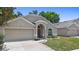 Well-maintained single-story home with a two-car garage, an arched entryway and a beautifully landscaped front yard at 700 Spring Cavern Ave, Orange City, FL 32763