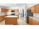 Bright kitchen featuring tan cabinets, stainless steel appliances, tile flooring and white countertops at 700 Spring Cavern Ave, Orange City, FL 32763