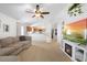 Open concept living room featuring neutral carpet, vaulted ceiling, and a view to the kitchen at 700 Spring Cavern Ave, Orange City, FL 32763