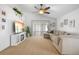 Spacious living room featuring a large sliding glass door, fireplace, and plush sectional seating at 700 Spring Cavern Ave, Orange City, FL 32763