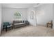 Bright living space featuring neutral carpet, large windows, and a sofa at 700 Spring Cavern Ave, Orange City, FL 32763