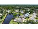 Aerial shot showcasing property's waterfront location, backyard, and mature landscaping at 706 Fox Tail Ct, New Smyrna Beach, FL 32168