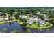 Beautiful aerial shot of the home and surrounding lush landscape featuring mature trees and a pond at 706 Fox Tail Ct, New Smyrna Beach, FL 32168