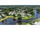 An aerial view highlighting the lush landscape, pond, and serene community around the property at 706 Fox Tail Ct, New Smyrna Beach, FL 32168