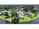 Back of home overlooking lake and features well-maintained landscaping and mature trees at 706 Fox Tail Ct, New Smyrna Beach, FL 32168
