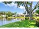 View of the property's waterfront backyard, featuring mature trees and lush green grass at 706 Fox Tail Ct, New Smyrna Beach, FL 32168