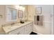 Bathroom featuring a dual-sink vanity, stylish mirrors and contemporary fixtures in a neutral color palette at 706 Fox Tail Ct, New Smyrna Beach, FL 32168