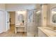 Bathroom featuring glass shower, oval mirror, vanity and modern fixtures, with an open door to the living area at 706 Fox Tail Ct, New Smyrna Beach, FL 32168