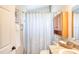 Bathroom featuring seashell shower curtain, light wood cabinet, and granite vanity at 706 Fox Tail Ct, New Smyrna Beach, FL 32168