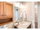Bathroom featuring wood cabinet, large mirror, granite vanity, and a sink at 706 Fox Tail Ct, New Smyrna Beach, FL 32168