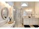 Bathroom featuring a glass-enclosed shower, dual vanities, and modern fixtures for a spa-like experience at 706 Fox Tail Ct, New Smyrna Beach, FL 32168