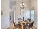 Bright dining area with modern light fixture and elegant decor, with an open view to hallway at 706 Fox Tail Ct, New Smyrna Beach, FL 32168