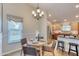 Cozy dining area with a chandelier and modern decor adjoining an updated kitchen at 706 Fox Tail Ct, New Smyrna Beach, FL 32168