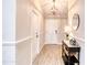 Bright foyer showcasing stylish flooring, wainscoting, and a decorative light fixture at 706 Fox Tail Ct, New Smyrna Beach, FL 32168