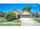 Charming single-story home featuring a well-manicured lawn and attractive landscaping at 706 Fox Tail Ct, New Smyrna Beach, FL 32168