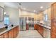 Well-equipped kitchen with wood cabinets, stainless steel appliances, and granite countertops at 706 Fox Tail Ct, New Smyrna Beach, FL 32168