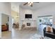 Cozy living room featuring a decorative fireplace and views into the dining and sitting areas at 706 Fox Tail Ct, New Smyrna Beach, FL 32168