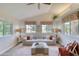 Comfortable living room with vaulted ceilings, neutral decor, and abundant natural light at 706 Fox Tail Ct, New Smyrna Beach, FL 32168