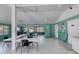 A bright meeting room with tables and chairs offers community members a welcoming space to connect and gather at 706 Fox Tail Ct, New Smyrna Beach, FL 32168