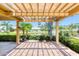 Covered patio featuring brick pavers, waterfront view, and lush landscaping at 706 Fox Tail Ct, New Smyrna Beach, FL 32168