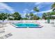The community pool is surrounded by lots of patio space and tall trees for shade in the hot Florida sun at 706 Fox Tail Ct, New Smyrna Beach, FL 32168