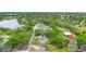 Aerial view of the neighborhood with lush greenery and a serene lake nearby at 910 Sheeler Oaks Dr, Apopka, FL 32703