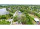 Aerial view of the neighborhood with lush greenery and a serene lake nearby at 910 Sheeler Oaks Dr, Apopka, FL 32703