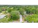 Aerial view of the neighborhood with lush greenery and mature trees at 910 Sheeler Oaks Dr, Apopka, FL 32703