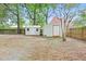 Large, fenced backyard with two sheds and mature trees offering ample shade at 910 Sheeler Oaks Dr, Apopka, FL 32703