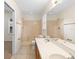 Bright bathroom features a double sink vanity and shower/tub combo at 910 Sheeler Oaks Dr, Apopka, FL 32703