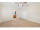 Bright bedroom features neutral walls, carpet, ceiling fan, and closet for ample storage at 910 Sheeler Oaks Dr, Apopka, FL 32703