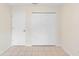Bedroom features tile flooring, neutral walls, a closet, and door to the outside at 910 Sheeler Oaks Dr, Apopka, FL 32703