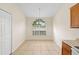 Dining area features tile floors and arched window overlooking the backyard at 910 Sheeler Oaks Dr, Apopka, FL 32703