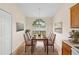 Elegant dining area with large window, neutral paint, and modern lighting at 910 Sheeler Oaks Dr, Apopka, FL 32703