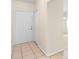 Entryway boasts tile flooring, neutral paint, and a white front door at 910 Sheeler Oaks Dr, Apopka, FL 32703