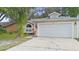 Charming single-story home with a two-car garage and well-maintained lawn at 910 Sheeler Oaks Dr, Apopka, FL 32703