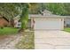 Charming single-story home with a two-car garage and well-maintained lawn at 910 Sheeler Oaks Dr, Apopka, FL 32703